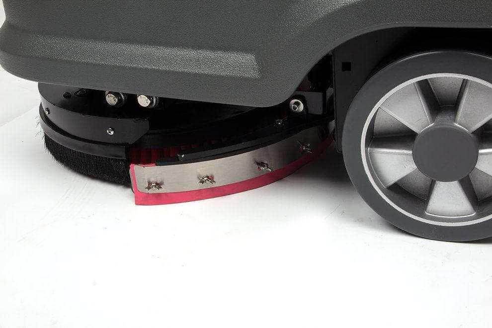 Close-up of RT15 Battery Powered commercial floor scrubber brush and wheel on white surface