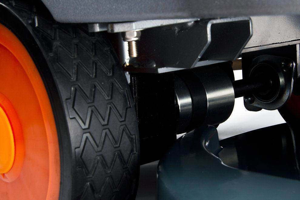 Close-up of RT50D+ self-propelled floor scrubber tire and mechanical components with orange wheel and black tread.